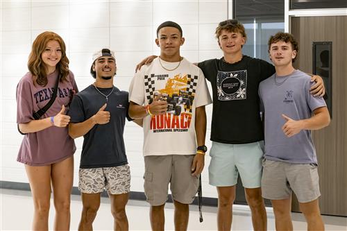 A girl and four boys standing together